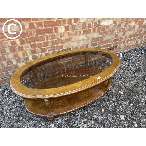 163 - A Dutch style oval coffee table with drop in glass top