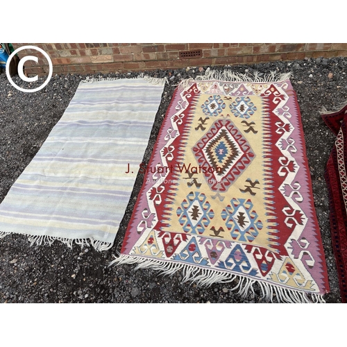 173 - A bright pattern Kilim together with a blue striped rug