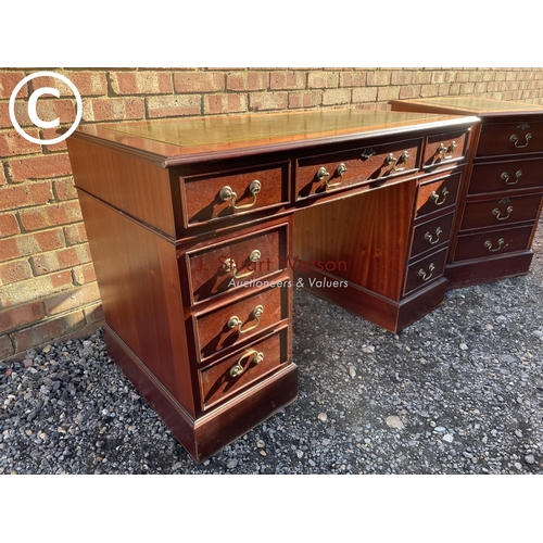 18 - A reproduction mahogany pedestal desk with a green leather top together with a matching two drawer f... 