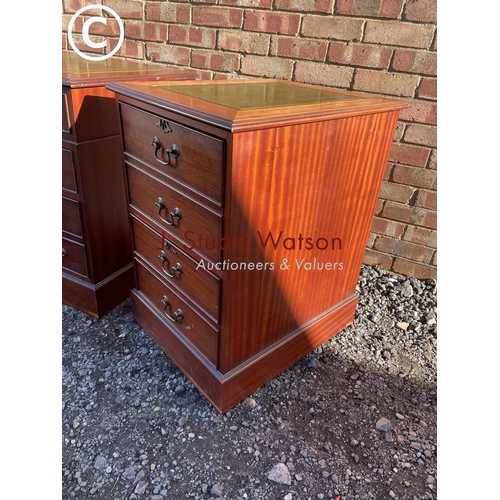 18 - A reproduction mahogany pedestal desk with a green leather top together with a matching two drawer f... 