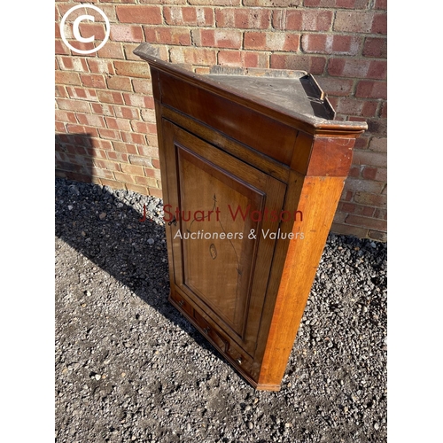 183 - An antique oak wall hanging corner corner cupboard with a painted interior