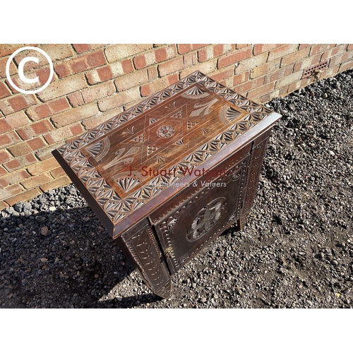 185 - A carved oak single door cupboard