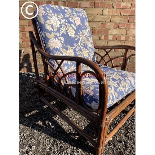 192 - A bamboo conservatory chair with blue pattern upholstered cushions