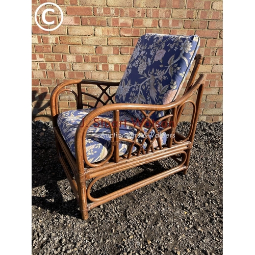 192 - A bamboo conservatory chair with blue pattern upholstered cushions