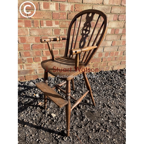 204 - An antique Elm wheelback child's high chair