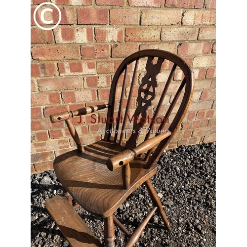 204 - An antique Elm wheelback child's high chair