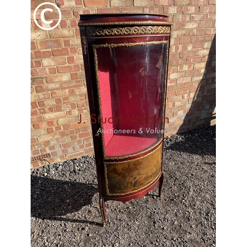 207 - A reproduction French style corner display cabinet with a bow glass front and decorated with gilt mo... 