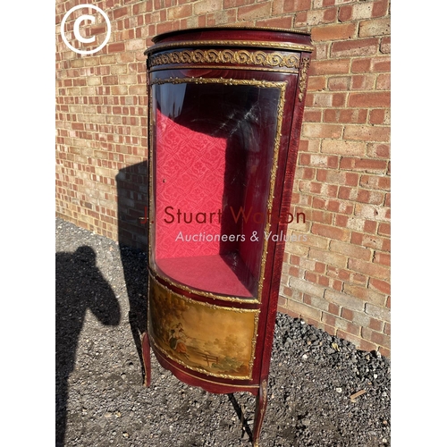 207 - A reproduction French style corner display cabinet with a bow glass front and decorated with gilt mo... 