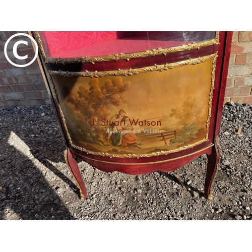 207 - A reproduction French style corner display cabinet with a bow glass front and decorated with gilt mo... 