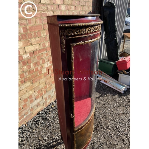 207 - A reproduction French style corner display cabinet with a bow glass front and decorated with gilt mo... 