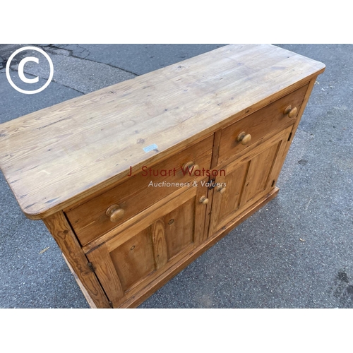 21 - An antique waxed pine two drawer dresser base