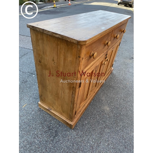 21 - An antique waxed pine two drawer dresser base