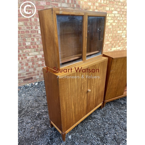 218 - A pair of mid century teak office cupboards, one having a glazed bookcase top