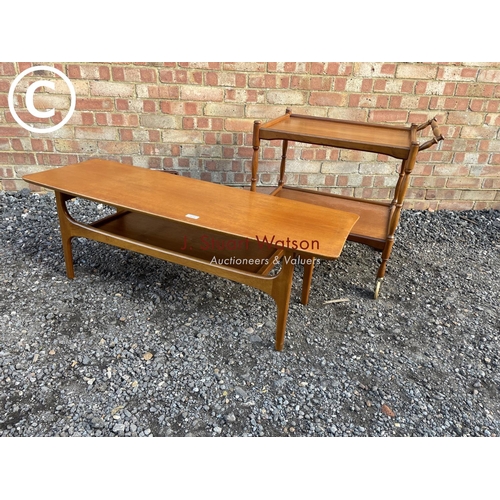 219 - A danish style teak coffee table together with a tea trolley