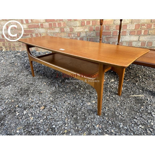 219 - A danish style teak coffee table together with a tea trolley