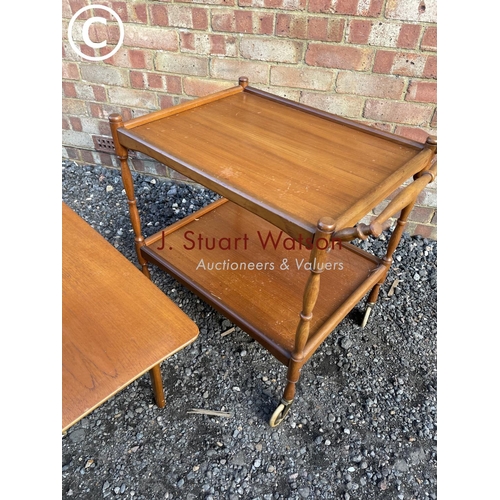 219 - A danish style teak coffee table together with a tea trolley