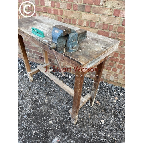 229 - A wooden workbench with vice