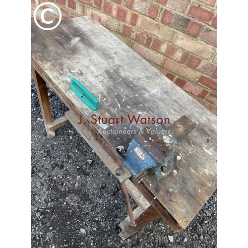 229 - A wooden workbench with vice