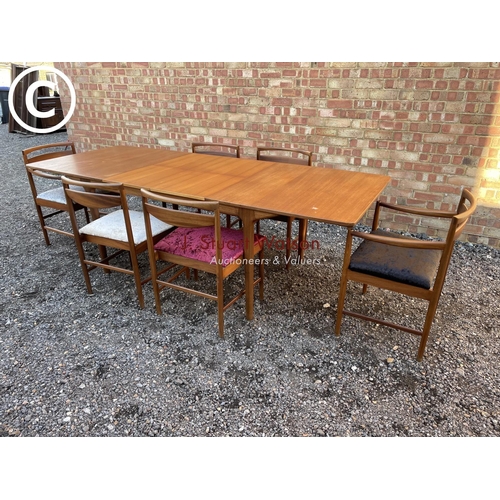 232 - A Macintosh teak two leaf rectangular extending dining table (chairs shown relate to previous lot)