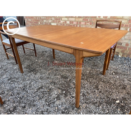 232 - A Macintosh teak two leaf rectangular extending dining table (chairs shown relate to previous lot)