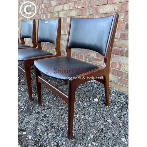 239 - A set of four Danish style teak framed dining chairs with black vinyl seats