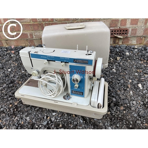 241 - A cased new home sewing machine