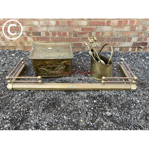 253 - A brass fender together a brass coal box and a brass bucket and tools