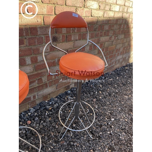 27 - A pair of orange 1970's swivel stools