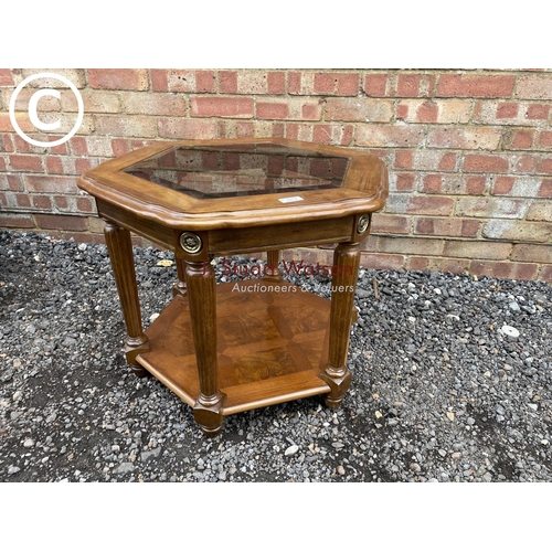 272 - An octagonal mahogany occasional table with drop in glass top