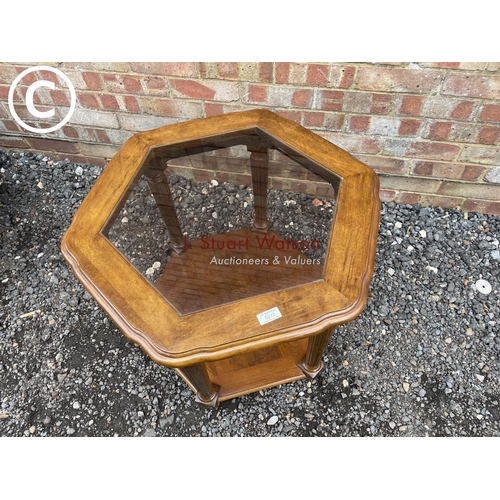 272 - An octagonal mahogany occasional table with drop in glass top