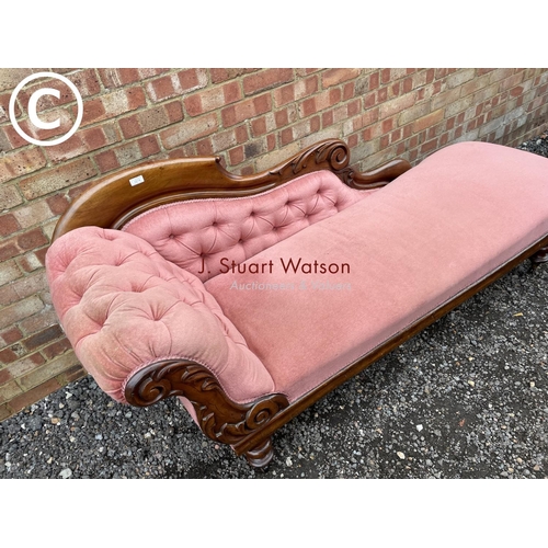 274 - A Victorian mahogany framed chaise lounge with pink buttoned upholstery