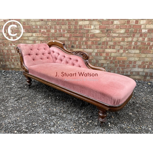 274 - A Victorian mahogany framed chaise lounge with pink buttoned upholstery