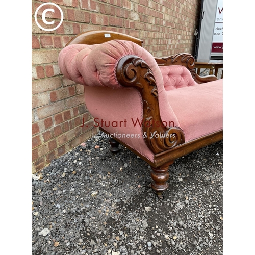 274 - A Victorian mahogany framed chaise lounge with pink buttoned upholstery