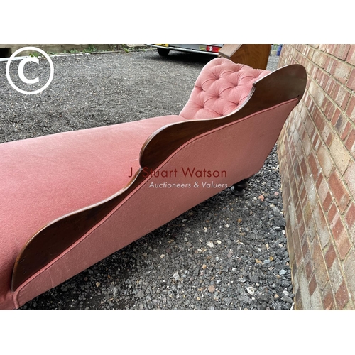 274 - A Victorian mahogany framed chaise lounge with pink buttoned upholstery