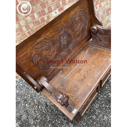 275 - A carved oak monks bench seat