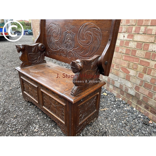 275 - A carved oak monks bench seat