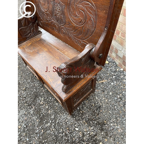 275 - A carved oak monks bench seat