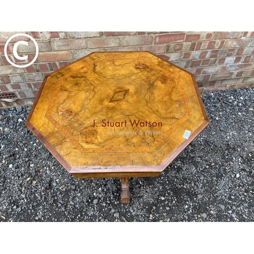 276 - An octagonal walnut occasional table