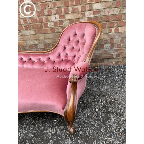 277 - A Victorian mahogany framed spoonback chaise lounge upholstered in pink (one foot AF but castors pre... 