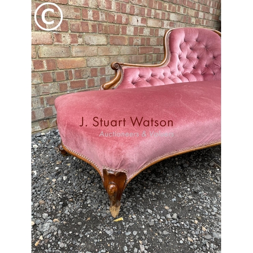 277 - A Victorian mahogany framed spoonback chaise lounge upholstered in pink (one foot AF but castors pre... 