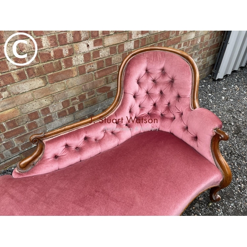 277 - A Victorian mahogany framed spoonback chaise lounge upholstered in pink (one foot AF but castors pre... 