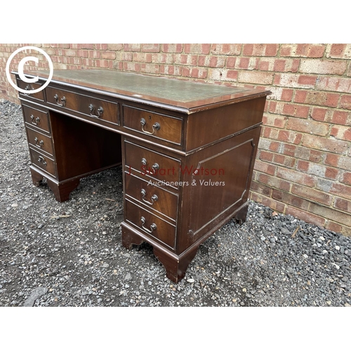 278 - A reproduction mahogany pedestal desk with a green leather top