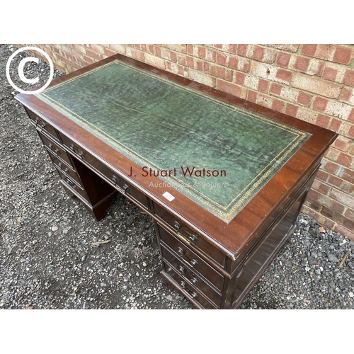 278 - A reproduction mahogany pedestal desk with a green leather top