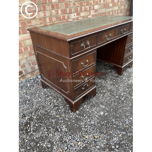 278 - A reproduction mahogany pedestal desk with a green leather top