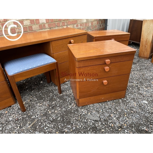 281 - A stag teak bedroom suite consisting of a dressing table, pair bedsides and a chest of three