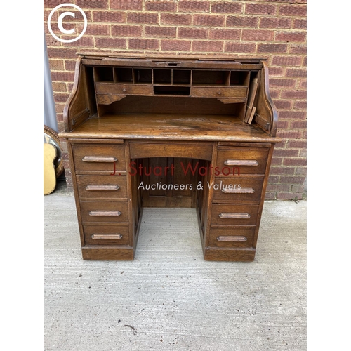 294 - A early 20th century oak roll top desk with fitted interior