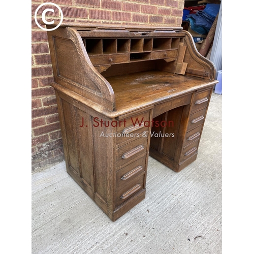 294 - A early 20th century oak roll top desk with fitted interior