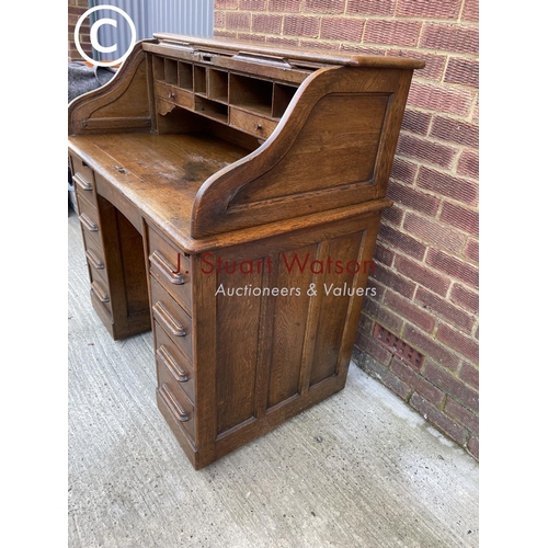 294 - A early 20th century oak roll top desk with fitted interior