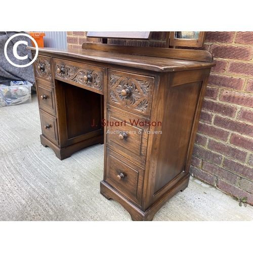 300 - A 20th century carved oak dressing table