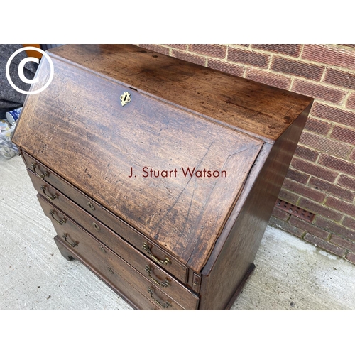 301 - An early Victorian mahogany bureau with a fitted interior